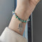 Bracelet Perles de Cristal Mains de Fatima et Breloque Vert irisé
